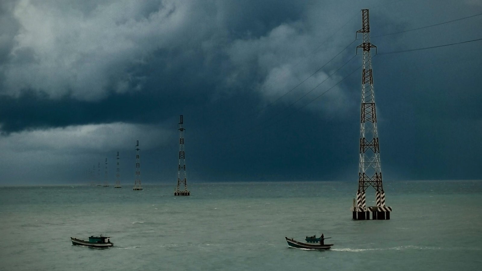 Electricity pylons crossing the ocean. Hon Son, Vietnam