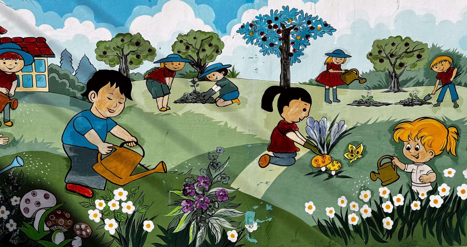 Colorful mural of children in a garden at a Vietnamese kindergarten